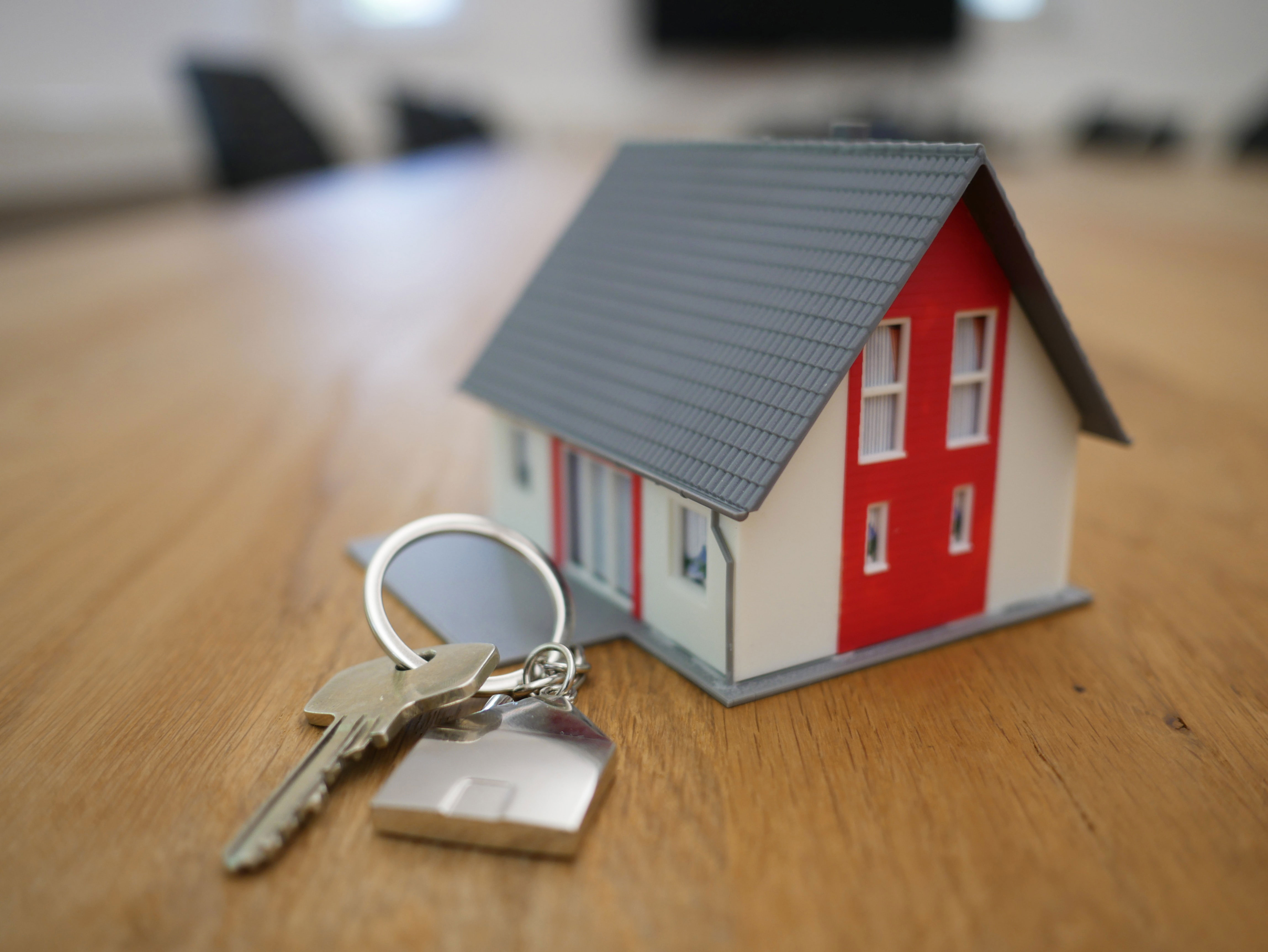 House model with magnifying glass and building plan